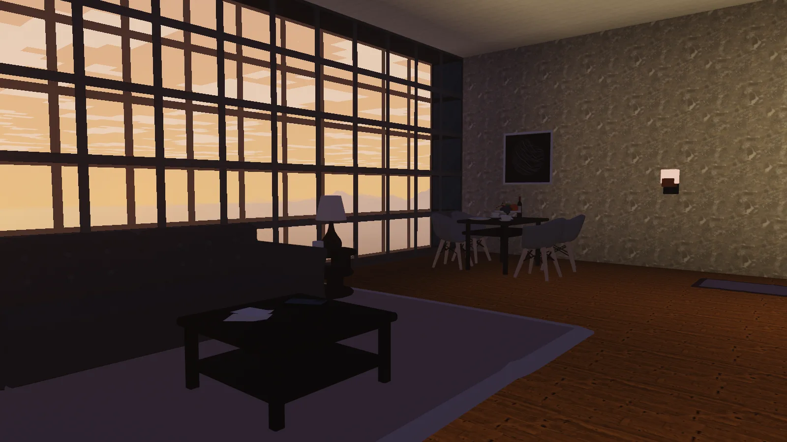 A furnished apartment at dusk, sofa and dining table beside a glass wall full of sunset