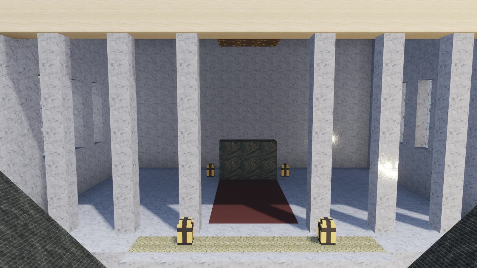A marble colonnade with a red carpet running between lit lanterns