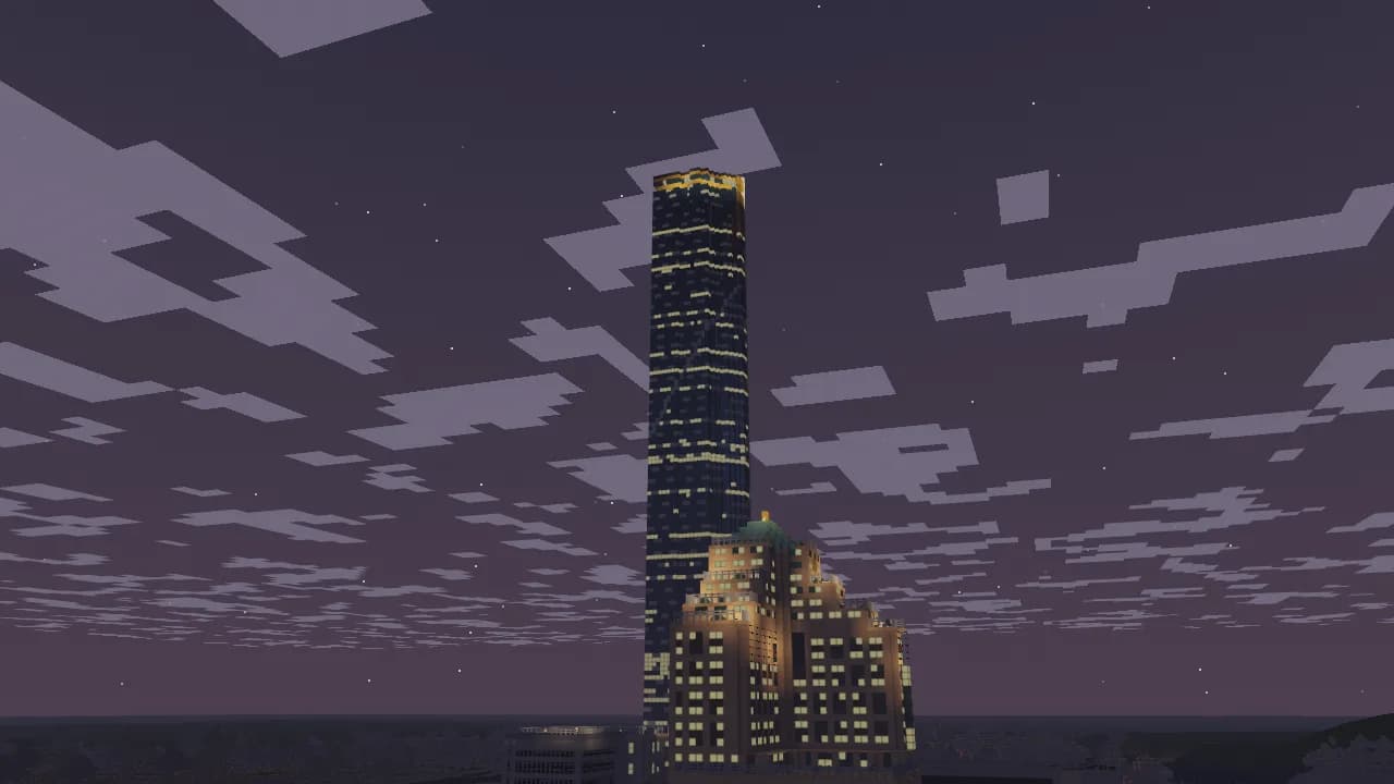 A dark tower speckled with lit windows rising into the night, a gold band at its crown, a lamplit hotel below
