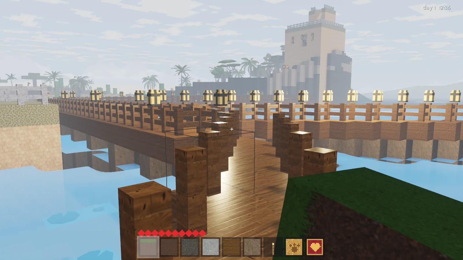 A lantern-lit timber pier running across a lagoon towards palms and a stone tower