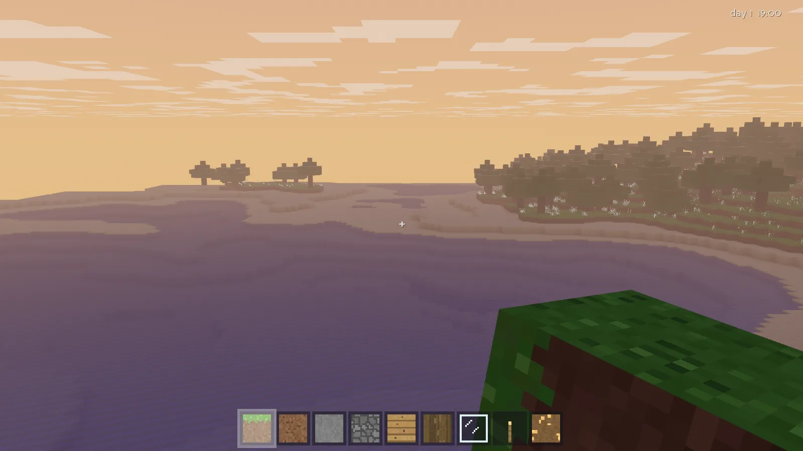 A calm voxel ocean and distant forest under an orange dusk sky